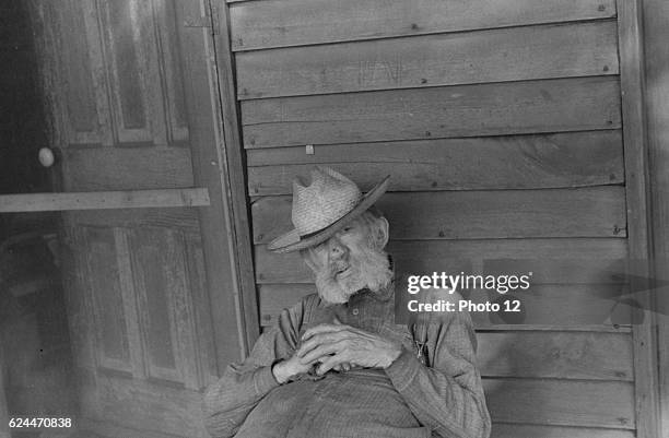 Ex-farmer resting by a house in Circleville, Ohio's 'Hooverville'. 1938.