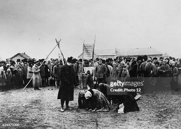 Hungry Russian women kneel before American Relief Administration officials during the great famine in Russia 1922.