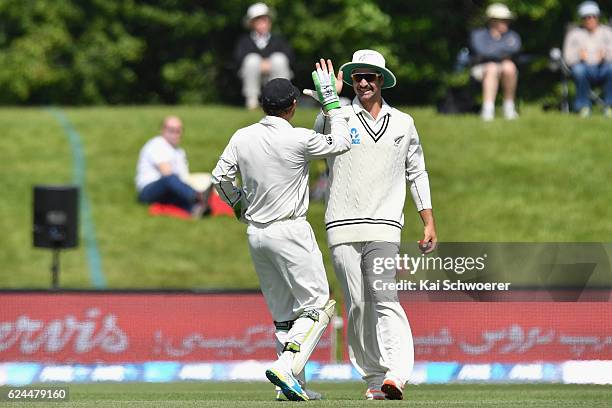 Colin de Grandhomme of New Zealand is congratulated by BJ Watling of New Zealand after taking a catch to dismiss Sohail Khan of Pakistan during day...