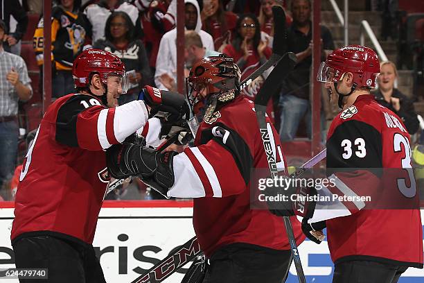 Shane Doan of the Arizona Coyotes celebrates with goaltender Mike Smith and Alex Goligoski after defeating the San Jose Sharks in the NHL game at...