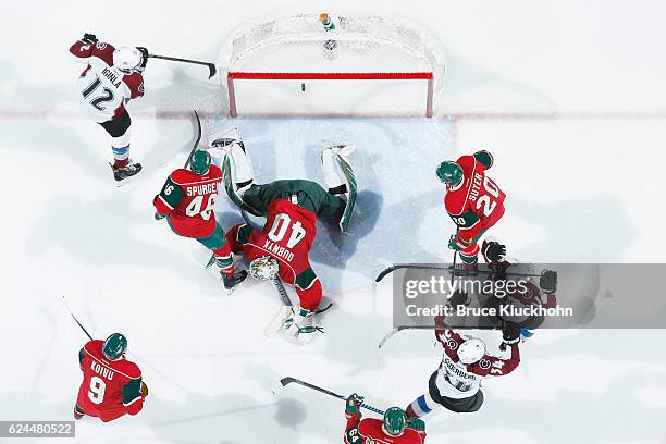 Jarome Iginla, Carl Soderberg, and Rene Bourque of the Colorado Avalanche celebrate after scoring a goal against Mikko Koivu, Jared Spurgeon, Devan...