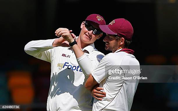 Matthew Renshaw and Joe Burns in the field during day four of the Sheffield Shield match between Queensland and South Australia at The Gabba on...