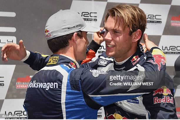 Driver Andreas Mikkelsen of Norway embraces teammate Sebastien Ogier of France after winning the Rally Australia in a Volkswagen Polo WRC car on the...