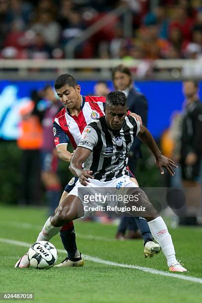 Orbelin Pineda of Chivas fights for the ball with Brayan Beckeles of Necaxa during the 17th round match between Chivas and Necaxa as part of the...