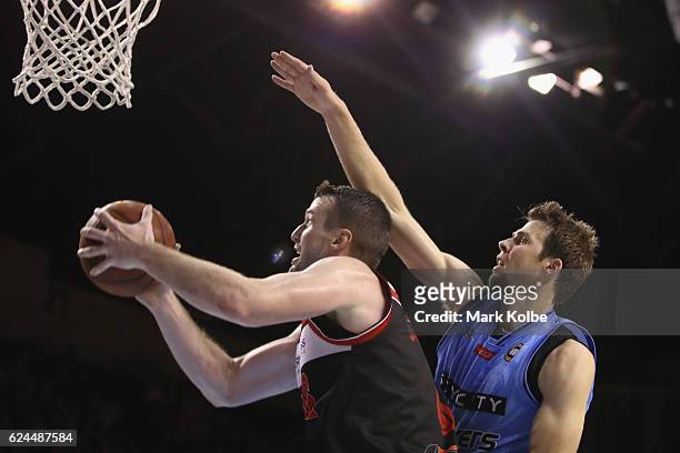 Ogilvy of the Hawks and Tom Abercrombie of the Breakers compete for the ball during the round seven NBL match between the Illawarra Hawks and the New...