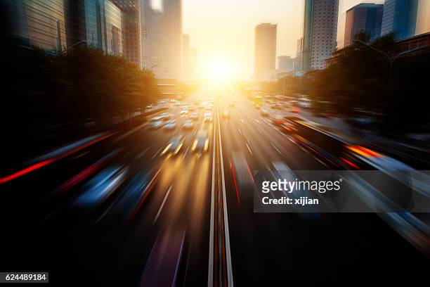 motion blur city traffic - driving sun stockfoto's en -beelden
