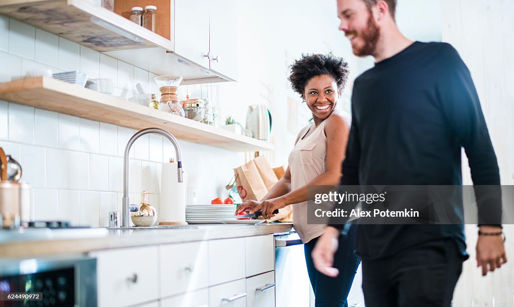 Young pretty black woman make soup in kitchen