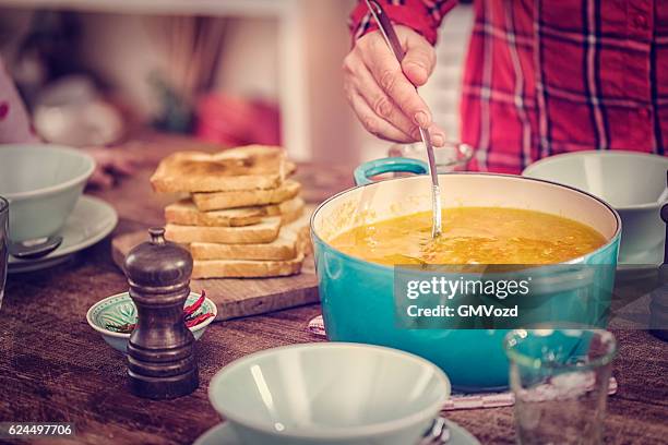 eating delicous chicken soup with carrots and parsnips - pepper pot stock pictures, royalty-free photos & images