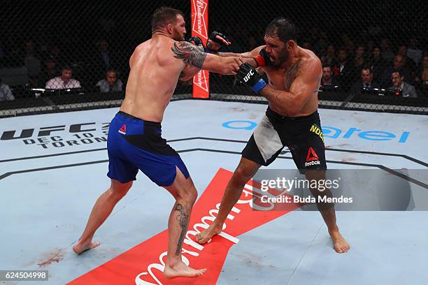 Ryan Bader of the United States and Antonio Rogerio Nogueira of Brazil exchange punches during their light heavyweight bout at UFC Fight Night Bader...