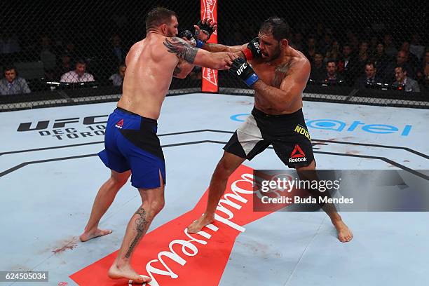 Ryan Bader of the United States and Antonio Rogerio Nogueira of Brazil exchange punches during their light heavyweight bout at UFC Fight Night Bader...