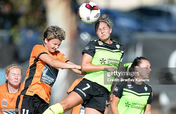 Ellie Brush of Canberra gets above Maili Forbes of the Roar as they compete for the ball during the round three W-League match between the Brisbane...
