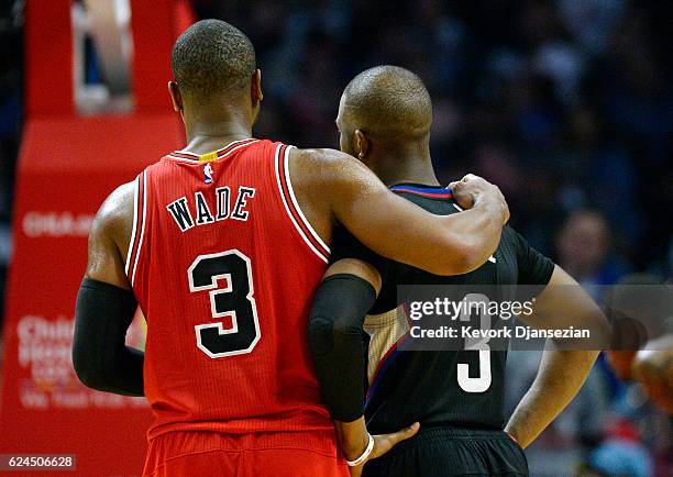 Dwyane Wade of the Chicago Bulls hugs Chris Paul of the Los Angeles Clippers during the second half of the basketball game at Staples Center November...