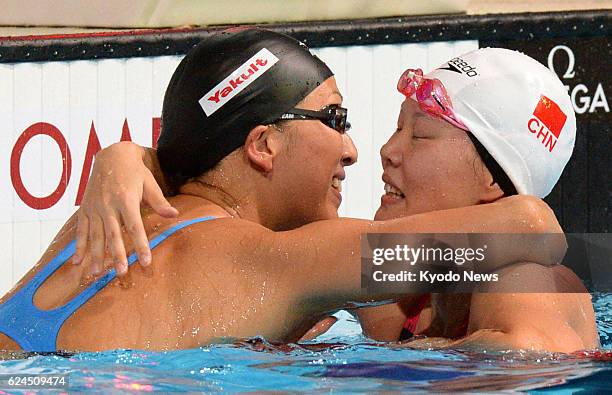 Spain - Japan's Aya Terakawa and China's Zhao Jing hug after the final of the women's 50-meter backstroke at the world swimming championships in...