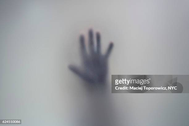 human hand seen through a frosted glass. - spooky fog stock pictures, royalty-free photos & images