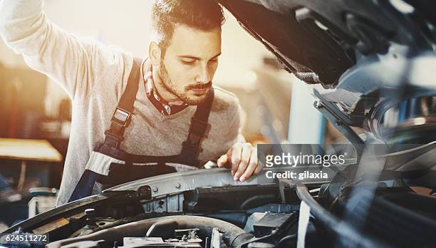 car mechanic inspecting engine during service procedure. - engine failure stock pictures, royalty-free photos & images