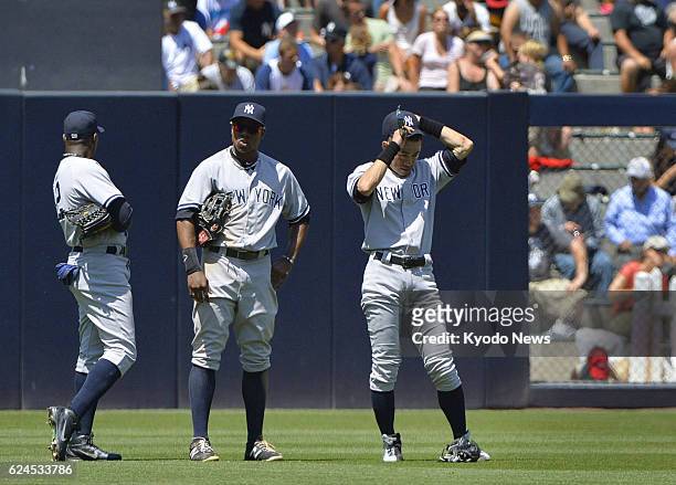 United States - New York Yankees outfielders Alfonso Soriano, Curtis Granderson and Ichiro Suzuki gather after starting pitcher Phil Hughes was...
