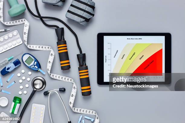 medical equipment by digital tablet displaying body mass index - body mass index chart stock pictures, royalty-free photos & images