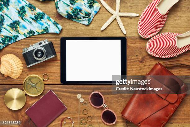 flat lay of digital tablet surrounded with beach and travel accessories - beach bag overhead stock pictures, royalty-free photos & images
