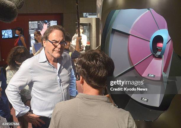 Japan - U.S. Film director Oliver Stone stands by a model of the atomic bomb dropped on Nagasaki, at the Nagasaki Atomic Bomb Museum on Aug. 7, 2013.