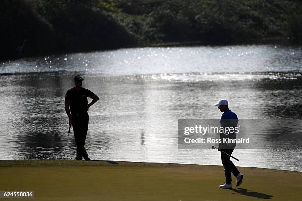 Henrik Stenson of Sweden and Rory McIlroy of Northern Ireland wait on the 17th green during day four of the DP World Tour Championship at Jumeirah...