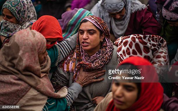 Relative of Rayees Ahmad, a pro Kashmir rebel killed in a gun battle with Indian government forces, is being consoled by relatives and neighbors,...