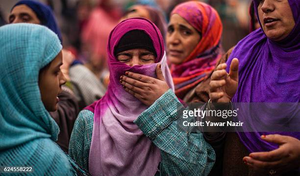 Relative of Rayees Ahmad, a pro Kashmir rebel killed in a gun battle with Indian government forces, is being consoled by relatives and neighbors,...
