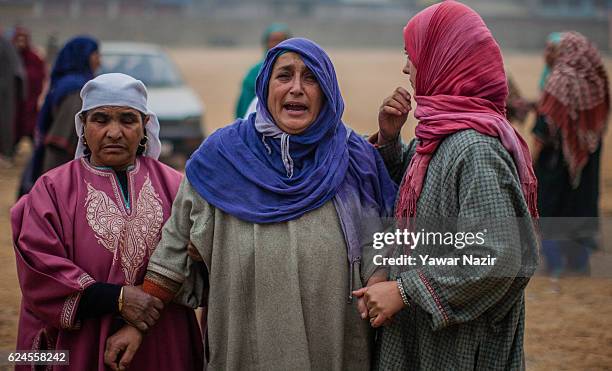 Mother of Rayees Ahmad, a pro Kashmir rebel killed in a gun battle with Indian government forces, is being consoled by relatives and neighbors,...
