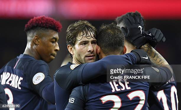 Paris Saint-Germain's Spain's forward Rodriguez Jese is congratuled by Brazilian defender teammate Maxwell after he scored a goal during the French...