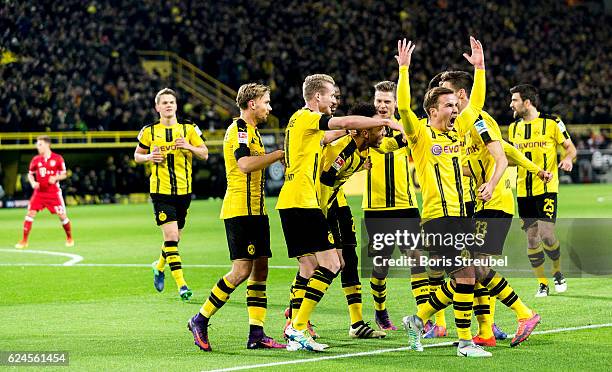 Pierre-Emerick Aubameyang of Borussia Dortmund celebrates with team mates after scoring his team's first goal during the Bundesliga match between...