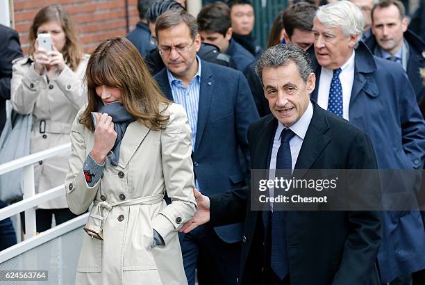 Former French President and presidential candidate hopeful Nicolas Sarkozy and his wife Carla Bruni-Sarkozy arrive to cast their votes during the...