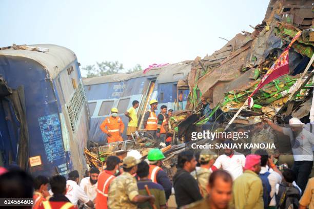 Indian rescue workers search for survivors in the wreckage of a train that derailed near Pukhrayan in Kanpur district on November 20, 2016. - A...