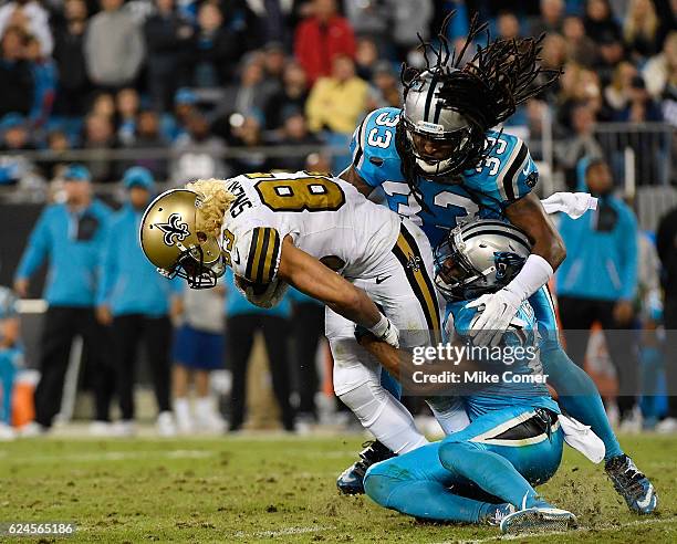 Robert McClain and Tre Boston of the Carolina Panthers tackle Willie Snead of the New Orleans Saints at Bank of America Stadium on November 17, 2016...