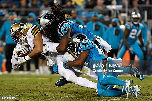 Robert McClain and Tre Boston of the Carolina Panthers tackle Willie Snead of the New Orleans Saints at Bank of America Stadium on November 17, 2016...