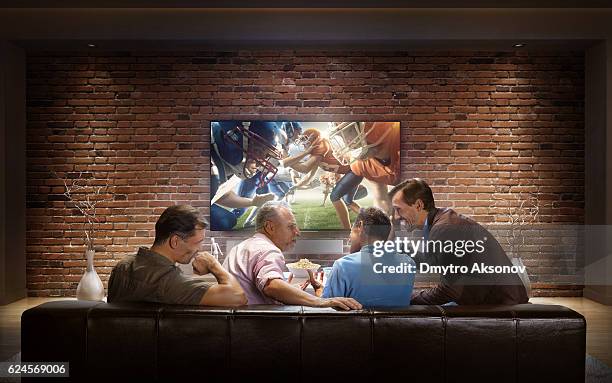 adults watching american football game at home - american football tv stock pictures, royalty-free photos & images