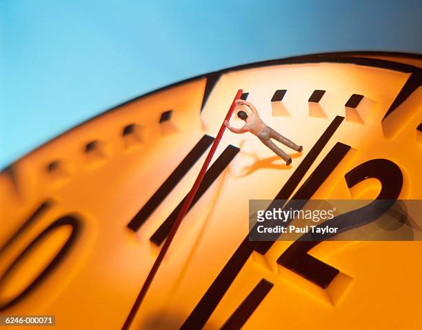 model man moving hand on clock - businessman figurine stock pictures, royalty-free photos & images
