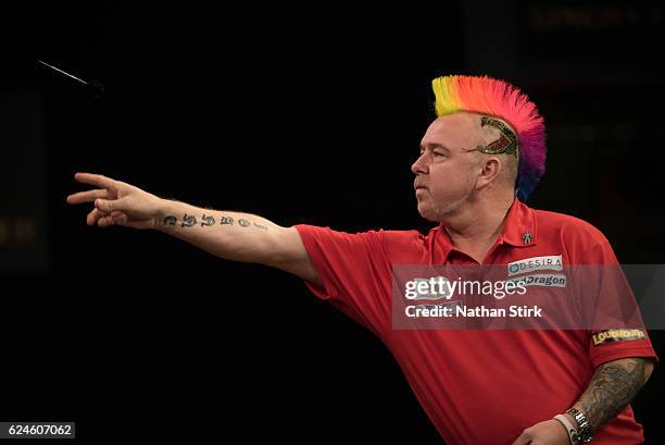 Peter Wright of Scotland plays a shot in his semi-final match against Michael van Gerwen of the Netherlands during the SINGHA Beer Grand Slam of...