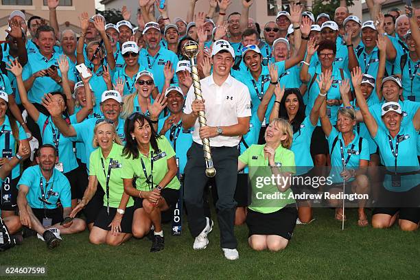Matt Fitzpatrick of England poses with the trophy and tournament staff following his victory during day four of the DP World Tour Championship at...