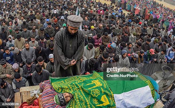 Kashmiri Muslim offer the funeral prayers nest to the body of Rayees Ahmad, a militant who was killed in a gun battle with the Indian government...