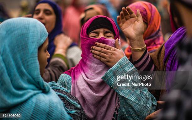 Relative mourns on seeing the body of Rayees Ahmad, a militant who was killed in a gun battle with the Indian government forces, during his funeral...