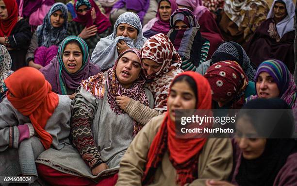 Relative mourns on seeing the body of Rayees Ahmad, a militant who was killed in a gun battle with the Indian government forces, during his funeral...