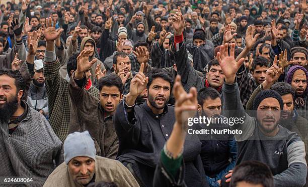 Kashmiri Muslims shout anti Indian and Pro Kashmir freedom slogans as they attend the funeral of Rayees Ahmad, a militant who was killed in a gun...