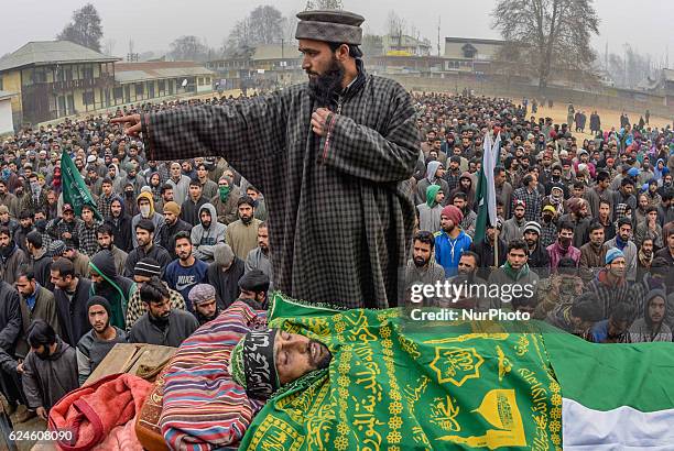 Kashmiri Muslim offer the funeral prayers nest to the body of Rayees Ahmad, a militant who was killed in a gun battle with the Indian government...