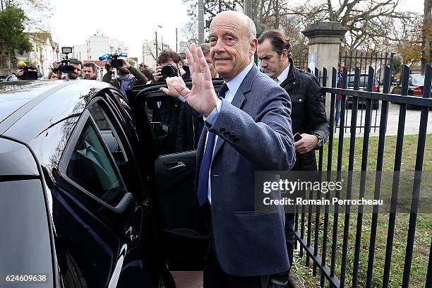 Alain Juppe, Mayor of Bordeaux and Les Republicains presidential candidate hopeful leave after casting his vote during the first round of voting in...