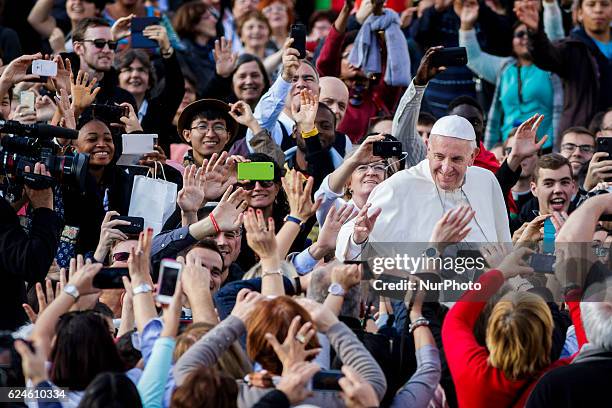 Pope Francis greets the faithful as he leaves at the end of a Holy Mass for the closing of the Jubilee of Mercy in St. Peter's Square in Vatican...