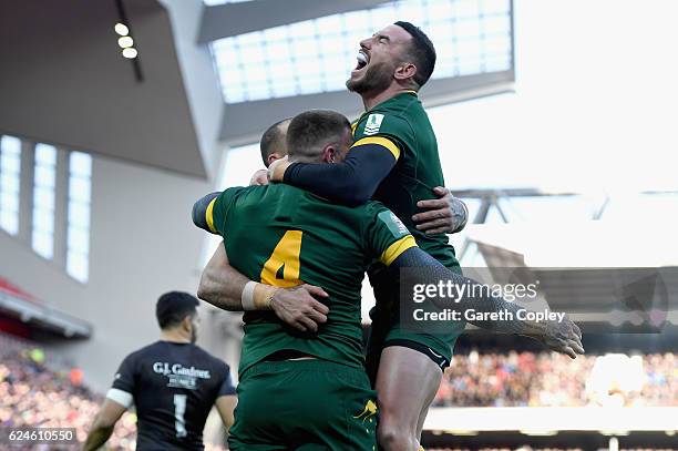 Josh Dugan of Australia is congratulated by Darius Boyd of Australia after scoring his team's second try during the Four Nations Final between New...