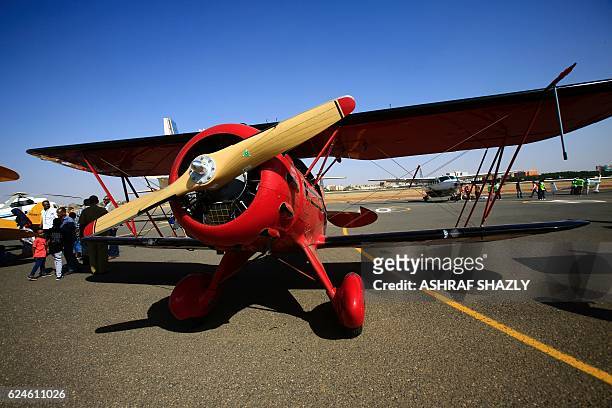Waco YMF-5D biplane sits on the runway on November 20, 2016 in Khartoum airport during the Vintage Air Rally . A dozen biplanes from the 1920s and...