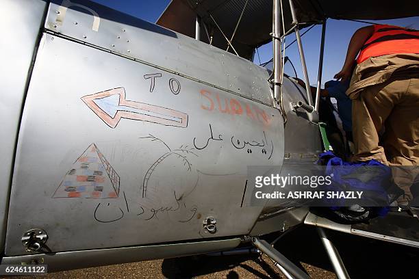 Arabic writting which reads 'going to Sudan' is seen on the vintage de Havilland Tiger Moth biplane as it sits on the runway on November 20, 2016 in...