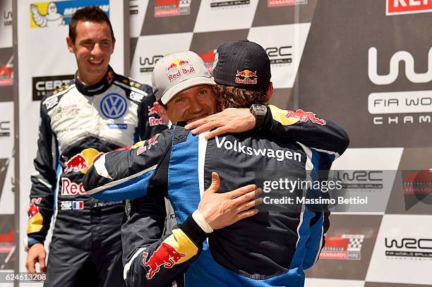 Julien Ingrassia of France and Sebastien Ogier of France congratulate their team mate Andreas Mikkelsen of Norway during Day Three of the WRC...