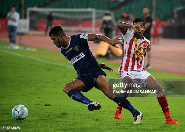 Chennaiyin FC defender Eli Sabia Filho vies for the ball with Atletico De Kolkata defender Keegan Pereiera during the Indian Super League football...