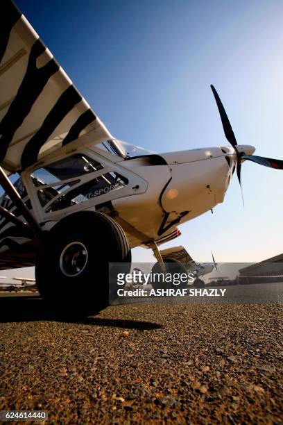 Rainbow Skyreach BushCat sport aircrafts sit on the runway on November 20, 2016 in Khartoum airport during the Vintage Air Rally . - A dozen biplanes...